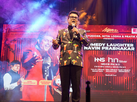 Navin Prabhakar anchoring a corporate event on stage